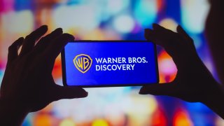 In this photo illustration, the Warner Bros. Discovery logo is displayed on a smartphone screen.