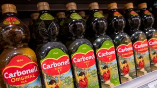 Bottles from the Spanish cooking and extra virgin olive oil brand Carbonell are seen displayed for sale at a supermarket.