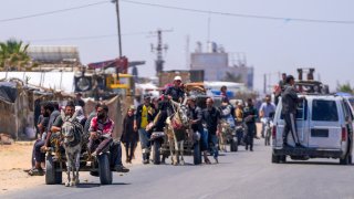 Displaced Palestinians arrive in central Gaza after fleeing from the southern Gaza city of Rafah in Deir al Balah, Gaza Strip, on Thursday, May 9, 2024.