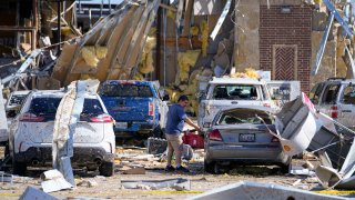 A man looks at a damaged car after a tornado hit the day before, Sunday, May 26, 2024, in Valley View, Texas.