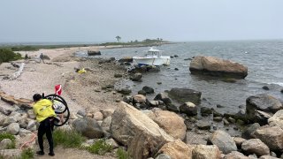 Boat against rocks in Madison.