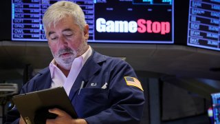 Traders work at the post where GameStop is traded on the floor at the New York Stock Exchange (NYSE) in New York City, U.S., June 12, 2024. 