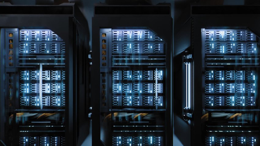 A large hallway with supercomputers inside a server room data center. 