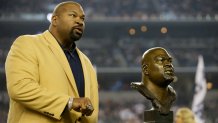 FILE - Dallas Cowboys Hall of Fame Inductee Larry Allen shows off his Hall of Fame ring at halftime of an NFL football game, Oct. 13, 2013, in Arlington, Texas. Allen, one of the most dominant offensive linemen in the NFL during a 12-year career spent mostly with the Dallas Cowboys, died suddenly on Sunday, June 2, 2024, while on vacation with his family in Mexico, the Cowboys said. He was 52.