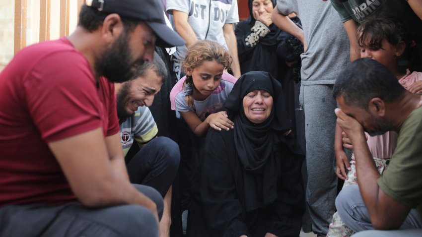 A Palestinian family mourns a loved one killed by Israeli bombardment , as they take a last look before their funeral in Khan Younis, southern Gaza Strip, Friday, June 21, 2024.