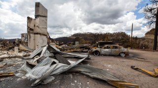 Charred vehicles and debris