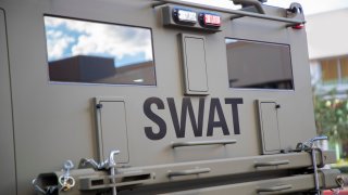 A close up of the SWAT sign on a SWAT police vehicle.