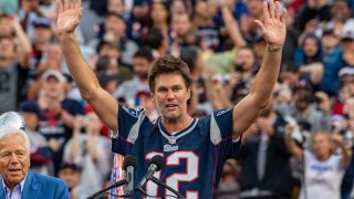 Former New England Patriots quarterback Tom Brady gestures as he speaks to fans as he is honored during halftime of the season-opening game between the Patriots and the Philadelphia Eagles at Gillette Stadium in Foxborough, Massachusetts, on September 10, 2023. Tom Brady played for 20 seasons with the New England Patriots. (Photo by Joseph Prezioso / AFP) (Photo by JOSEPH PREZIOSO/AFP via Getty Images)