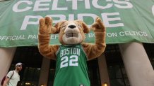 A goat mascot in a Celtics jersey in front of a "CELTICS PRIDE" sign hanging on a building in Boston before the championship parade Friday, June 21, 2024.