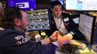 Traders work on the floor of the New York Stock Exchange on April 26, 2023 in New York City. 