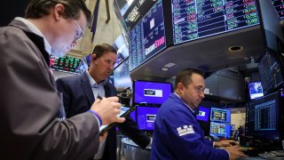 Traders work at the post where GameStop is traded on the floor of the New York Stock Exchange, June 12, 2024.