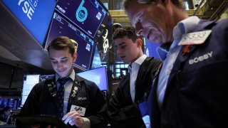 Traders work on the floor at the New York Stock Exchange (NYSE) in New York City, U.S., June 24, 2024. 