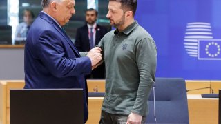 Hungarian Prime Minister Viktor Orban (L) talks with Ukrainian President Volodymyr Zelenskyy (R) in the Europa building prior the start of the meeting on June 27, 2024, in Brussels, Belgium.