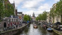 Tourists visiting the city take boat trips on the canals in Amsterdam, Netherlands on May 25, 2024. 