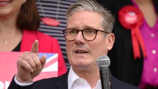 Labour Leader, Sir Keir Starmer (C) gestures as he delivers a stump speech to supporters during a campaign visit to Hucknall Town Football Club on July 2, 2024 in Nottingham, United Kingdom. 