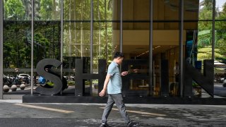 A man walking past a logo of fast fashion e-commerce company Shein outside its office in Guangzhou in southern China’s Guangdong province. 