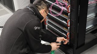 A GroqNode rack is installed by a member of the Groq team at Argonne National Laboratory in Illinois, U.S.
