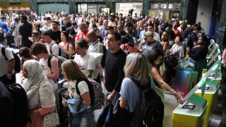 People wait for their flight after a global outage at LaGuardia Airport in the Queens borough of New York, on July 19, 2024. 