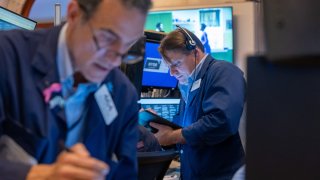 Traders work on the floor of the New York Stock Exchange (NYSE) on July 24, 2024 in New York City.