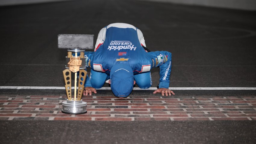 Kyle Larson, driver of the No. 5 HendrickCars.com Chevrolet, kisses the yard of bricks after winning the NASCAR Cup Series Brickyard 400 at Indianapolis Motor Speedway on July 21, 2024 in Indianapolis, Indiana.