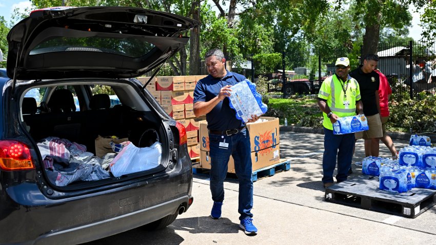 Volunteers hand out water at a distribution station in Houston.