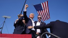 Republican presidential candidate former President Donald Trump gestures as he is surrounded by U.S. Secret Service agents as he leaves the stage at a campaign rally, Saturday, July 13, 2024, in Butler, Pa. (AP Photo/Evan Vucci)