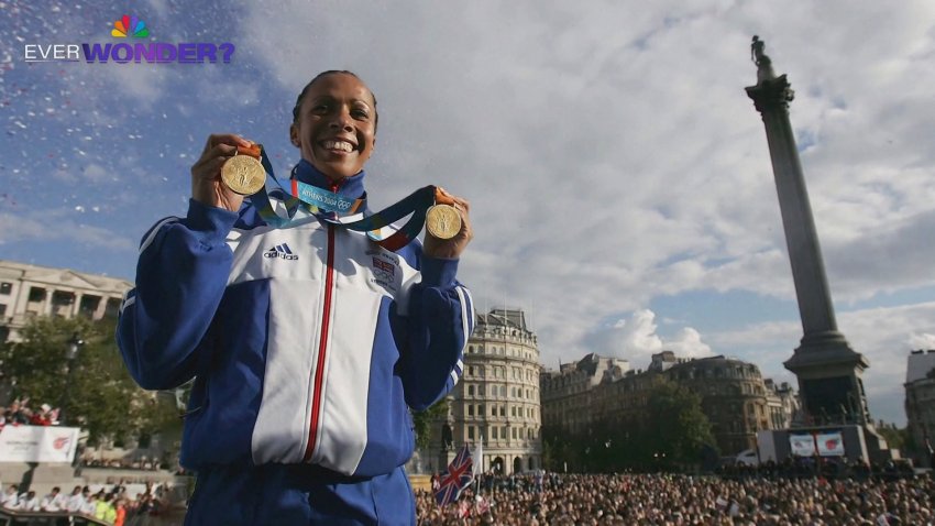 British Olympian Kelly Holmes holds up her medals