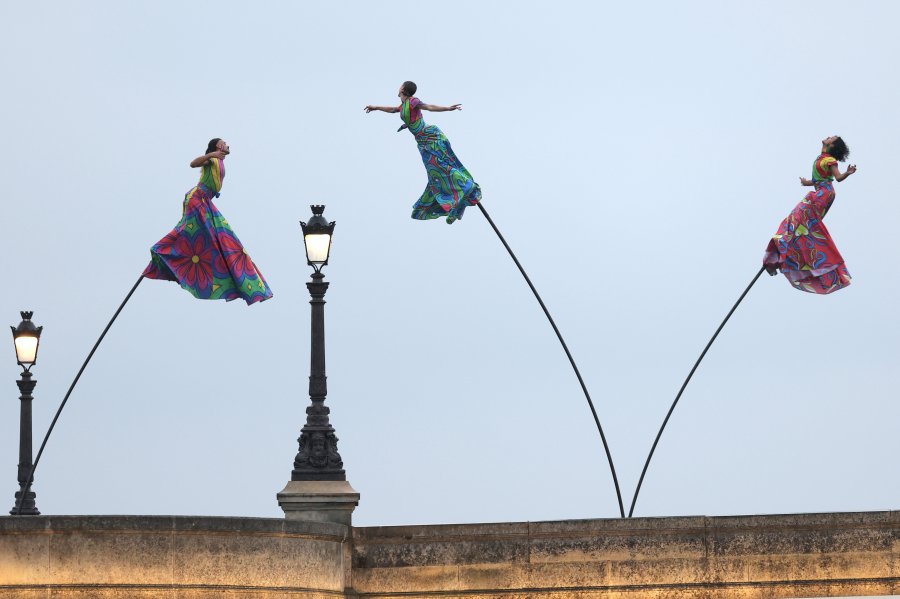 Performers perform on a bridge