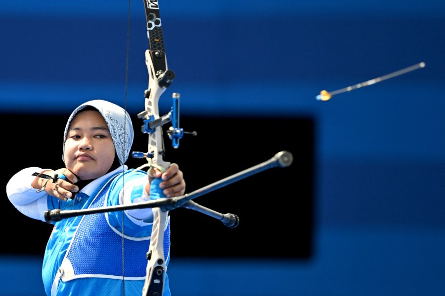 Malaysia's Syaqiera Mashayikh competes in the archery women's individual elimination round during the Paris 2024 Olympic Games at the Esplanade des Invalides in Paris on July 30, 2024.