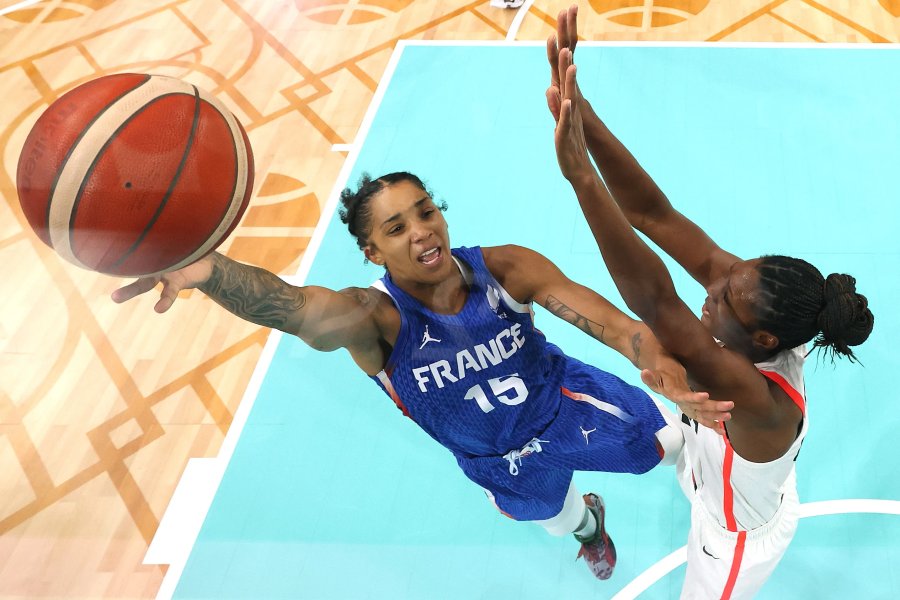 Gabby Williams of Team France goes up for a basket past Kayla Alexander of Team Canada