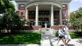 Students walk outside the Collis building on the campus of Dartmouth College, the smallest school in the Ivy League, in Hanover, New Hampshire.