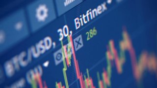 Photo illustration of Bitfinex cryptocurrency exchange website.