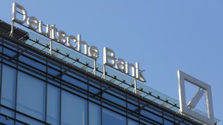 A logo stands on display above the headquarters of Deutsche Bank AG at the Aurora Business Park in Moscow, Russia.