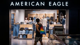 A shopper walks past the American clothing and accessories retailer American Eagle store in Hong Kong.