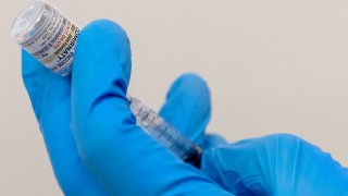 A health care worker prepares an injection of Pfizer’s Covid-19 vaccine Comirnaty, Sept. 14, 2023.