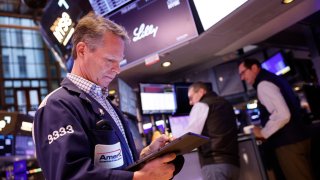 Traders work on the floor of the New York Stock Exchange during morning trading on Feb. 23, 2024.