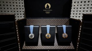 The 2024 Paris Olympic Games medals are displayed inside a custom-designed trunk manufactured by Louis Vuitton, an LVMH brand partner of the Paris Olympic and Paralympic Games, during a gathering at LVMH in Paris on July 22, 2024, ahead of the start of the 2024 Paris Olympic Games. 