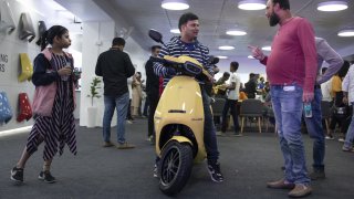 Customers browse the S1 Pro electric scooter of Ola Electric Mobility Pvt. at the launch event of Ola Experience Center in Bengaluru, India, on Sunday, Nov. 27, 2022. Ola opened three showrooms called Ola Experience Centres in Bengaluru on Sunday. Photographer: Samyukta Lakshmi/Bloomberg via Getty Images