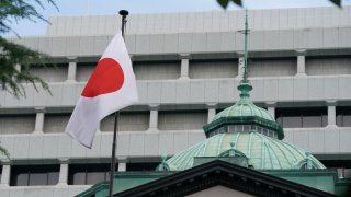 The Japanese national flag is seen at the Bank of Japan (BoJ) headquarters in Tokyo on July 31, 2024. The Bank of Japan lifted its main interest rate on July 31 for just the second time in 17 years in another step away from its massive monetary easing programme.