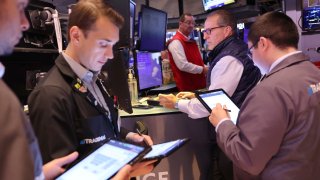 Traders work on the floor of the New York Stock Exchange during morning trading on August 06, 2024 in New York City. 