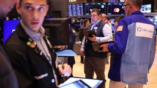 Traders work on the floor of the New York Stock Exchange during morning trading on August 06, 2024 in New York City. 