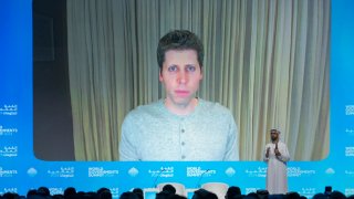 Sam Altman, OpenAI CEO (on screen) speaks in a videocall with Omar al-Olama, Minister of State for Artificial Intelligence, Digital Economy and Remote Work Applications, during the World Government Summit in Dubai on February 13, 2024. 