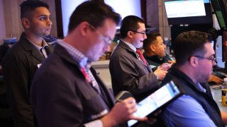 Traders work on the floor of the New York Stock Exchange during morning trading on August 23, 2024 in New York City. 