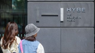 SEOUL, SOUTH KOREA – 2024/04/23: People walk past the Hybe Building in Seoul. 