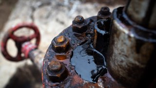 Crude oil leaks from an oil pumping jack in an oil field in Russia.