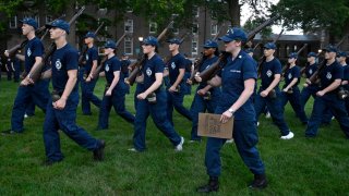 Swabs march under the eye of second class cadets known as cadre at the U.S. Coast Guard Academy, Monday, July 15, 2024, in New London, Conn. (AP Photo/Jessica Hill)