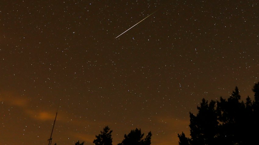 a streak appears in the sky during the annual Perseid meteor showe