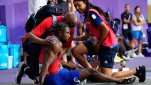 Noah Lyles, of the United States, is treated by medical staff following the men's 200-meters final at the 2024 Summer Olympics, Thursday, Aug. 8, 2024, in Saint-Denis, France. (AP Photo/Petr David Josek)