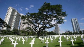 FILE - Crosses dot the Manila American Cemetery