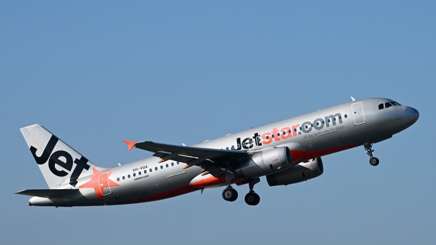 A JetStar plane is departing Melbourne Airport in Melbourne.